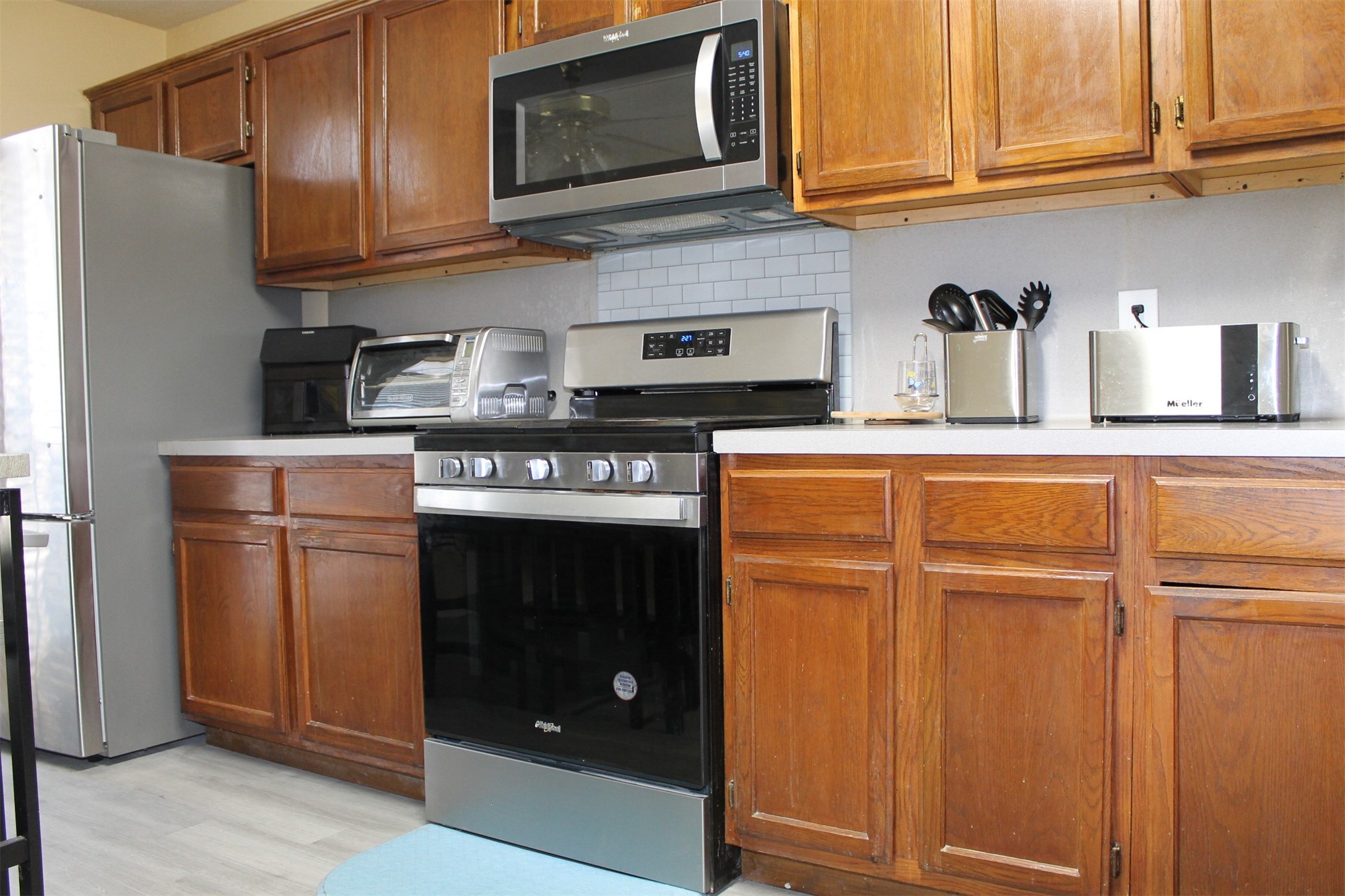 15818 Camp Fire Road Friendswood, TX 77546 - Photo 14 of 36 a kitchen with stainless steel appliances granite countertop a refrigerator stove and cabinets