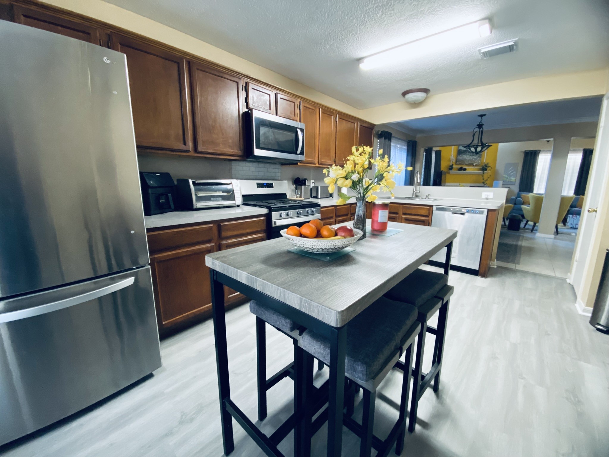 15818 Camp Fire Road Friendswood, TX 77546 - Photo 15 of 36 a kitchen with a table chairs and a refrigerator
