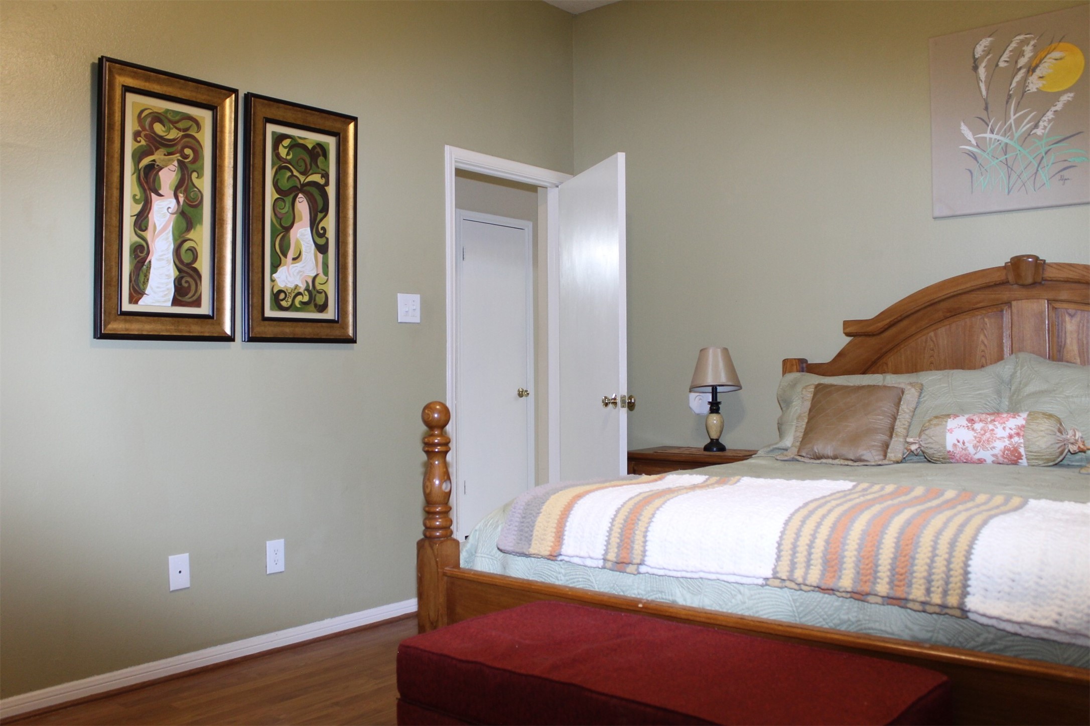 15818 Camp Fire Road Friendswood, TX 77546 - Photo 19 of 36 a bedroom with a bed and wooden floor