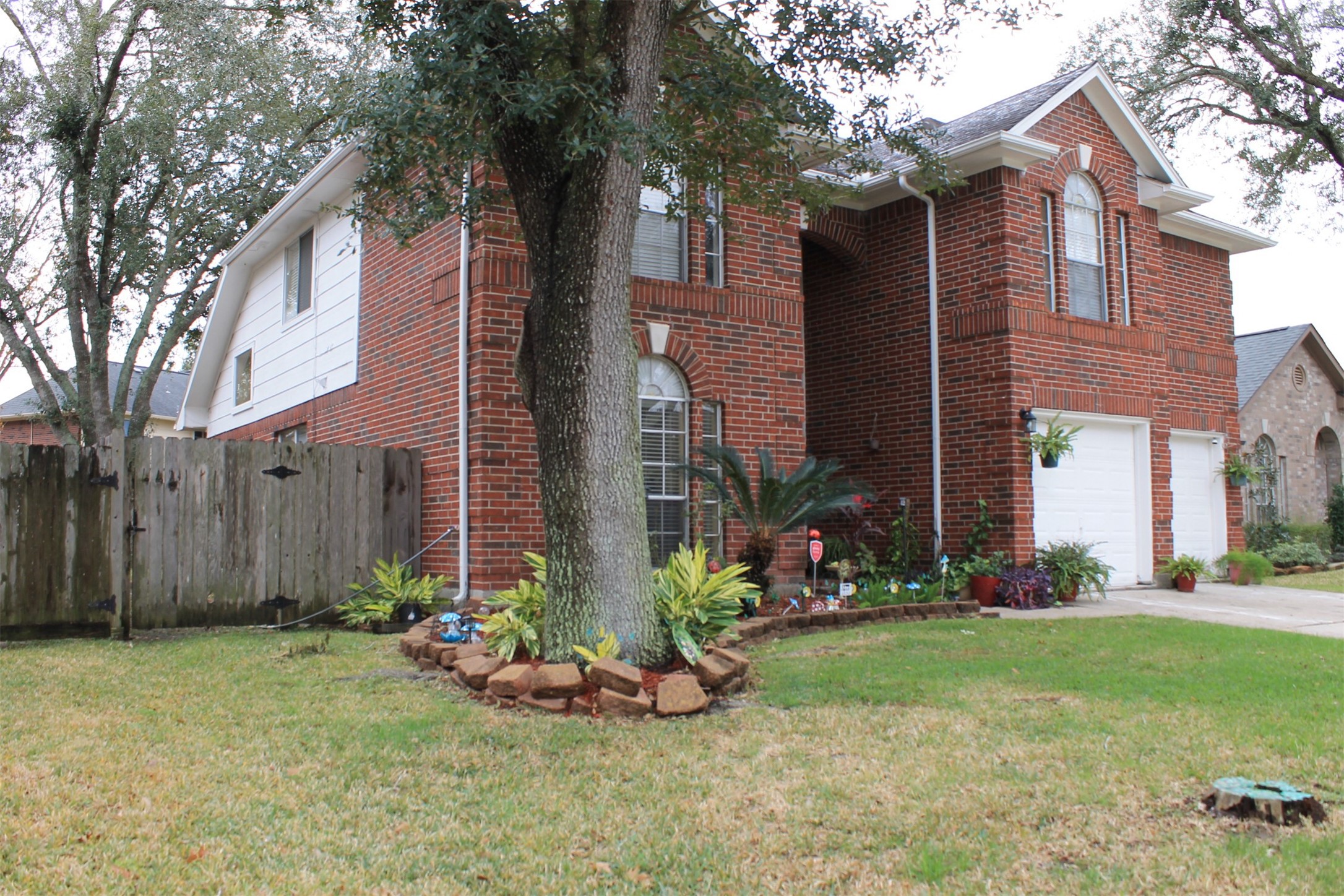 15818 Camp Fire Road Friendswood, TX 77546 - Photo 2 of 36 a view of a house with a yard and plants