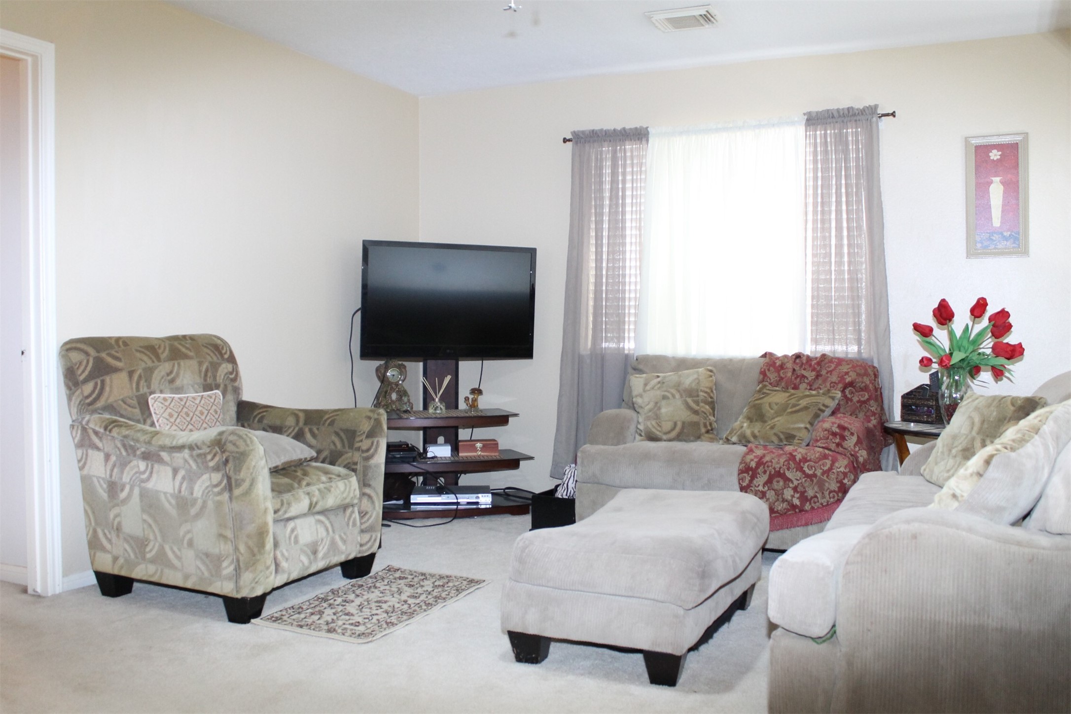 15818 Camp Fire Road Friendswood, TX 77546 - Photo 24 of 36 a living room with furniture and a flat screen tv