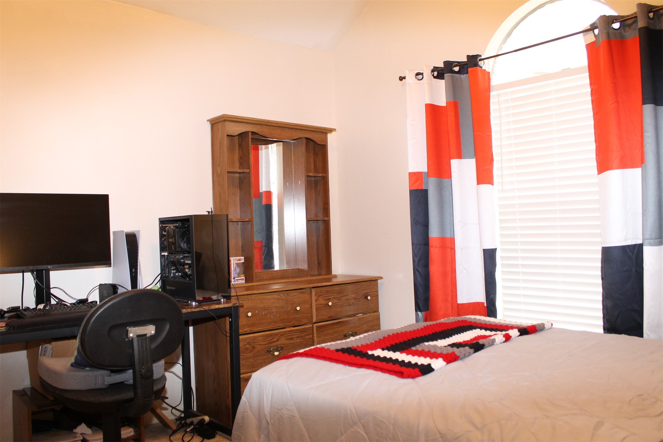 15818 Camp Fire Road Friendswood, TX 77546 - Photo 27 of 36 a bedroom with a bed and a flat screen tv