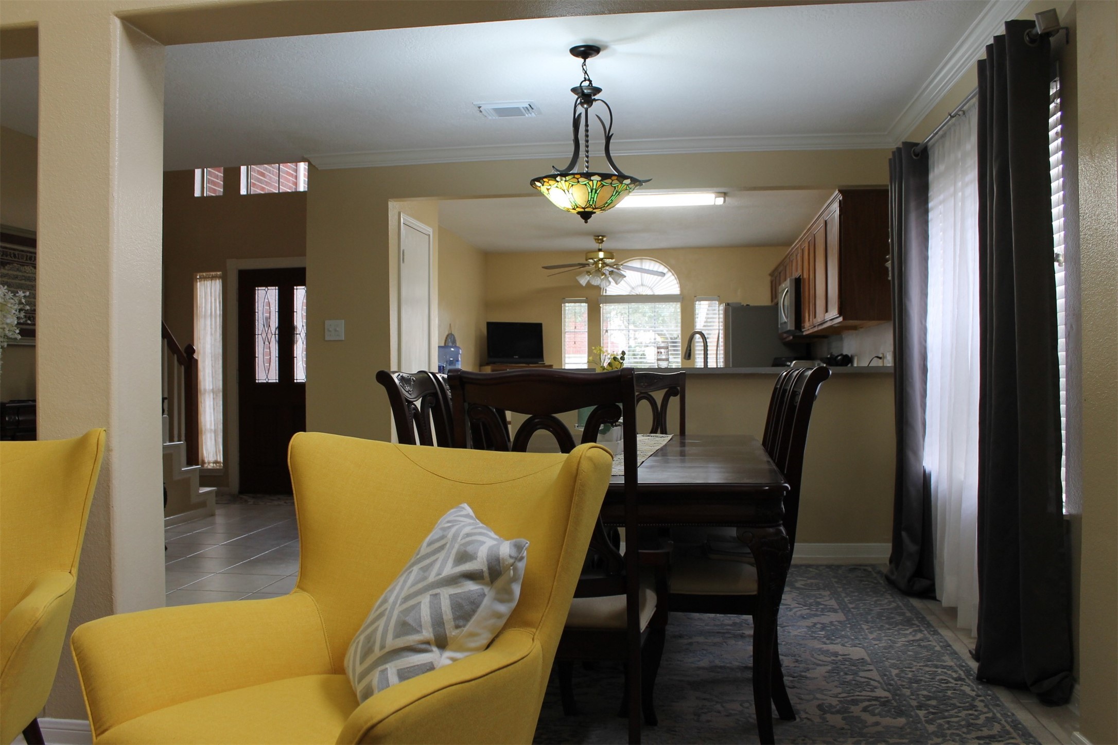 15818 Camp Fire Road Friendswood, TX 77546 - Photo 10 of 36 a view of a dining room with furniture and a chandelier