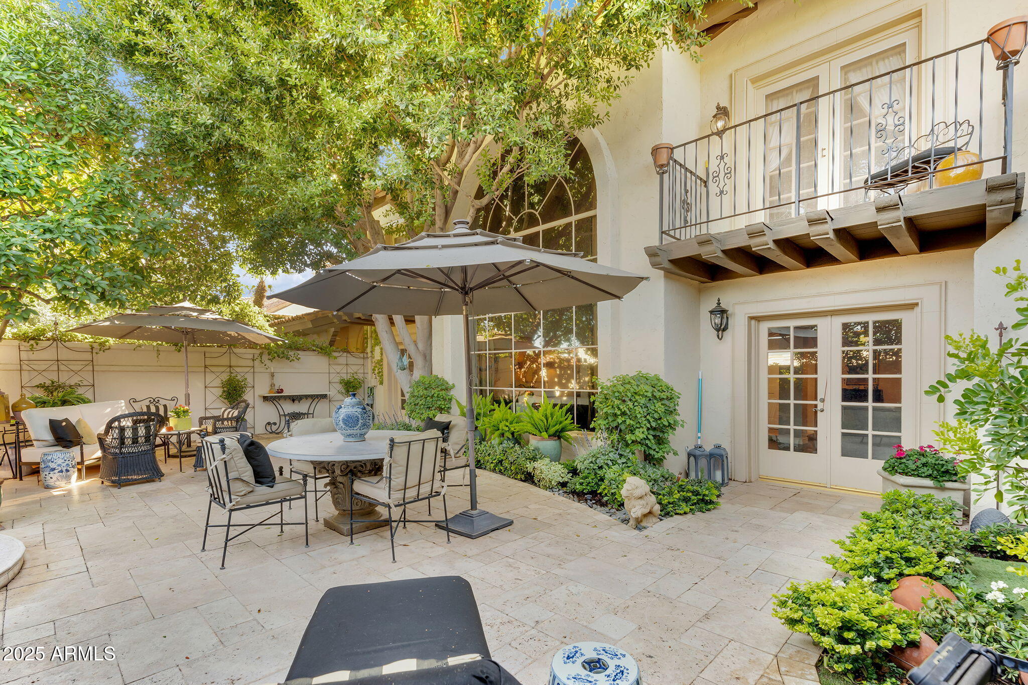 6701 North Scottsdale Road, Unit 16 Scottsdale, AZ 85250 - Photo 64 of 83 a view of a patio with table and chairs under an umbrella