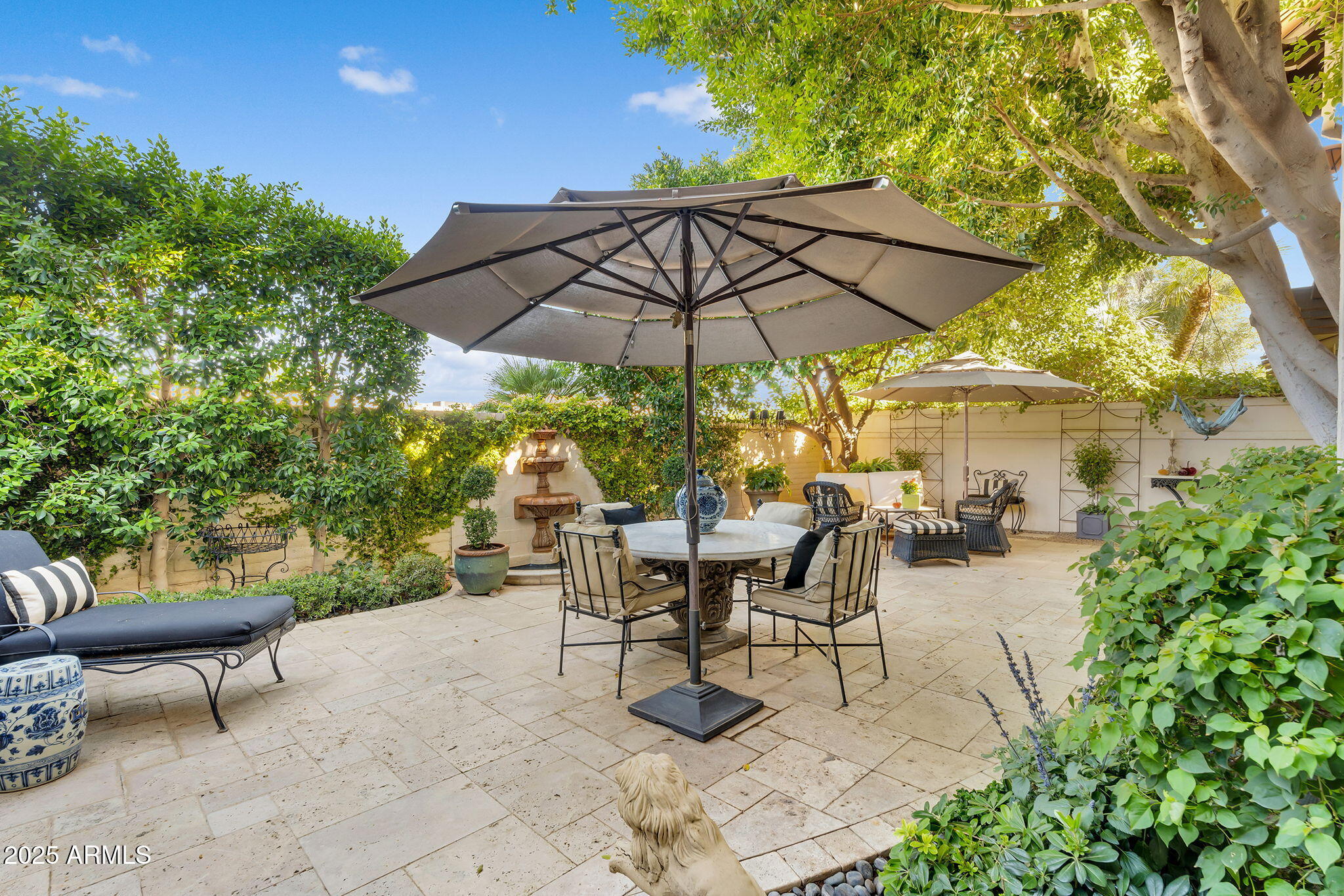 6701 North Scottsdale Road, Unit 16 Scottsdale, AZ 85250 - Photo 68 of 83 a view of a patio with a table and chairs under an umbrella