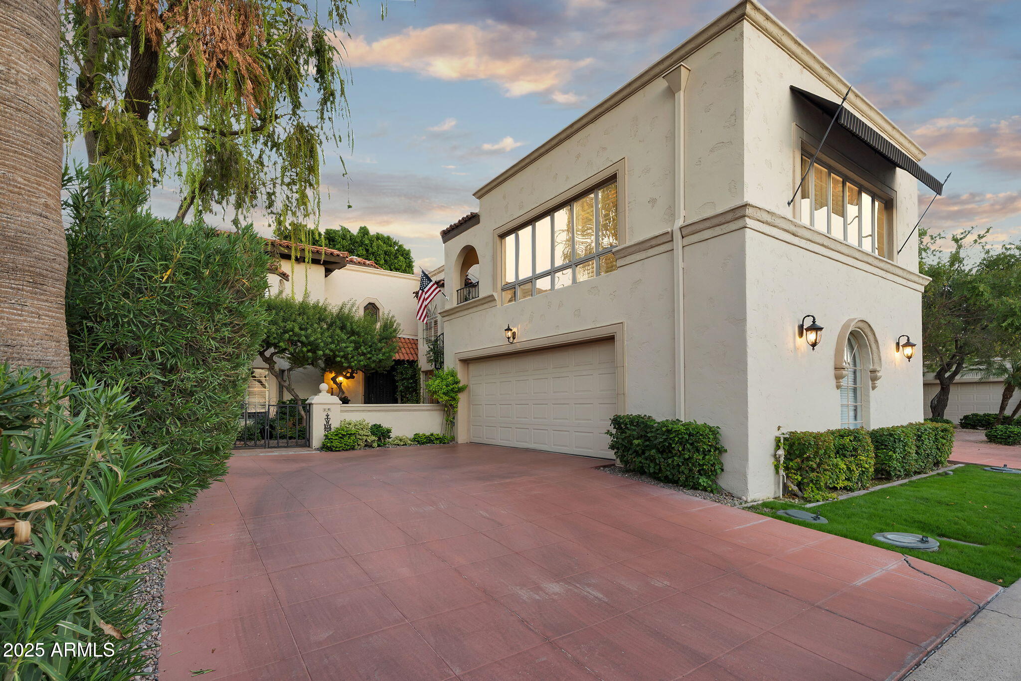 6701 North Scottsdale Road, Unit 16 Scottsdale, AZ 85250 - Photo 81 of 83 a front view of a house with a yard and garage