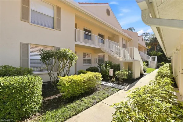 a view of a house with potted plants