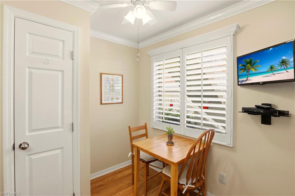289 Robin Hood Circle, Unit 101 Naples, FL 34104 - Photo 13 of 47 a view of a room with a table and chairs