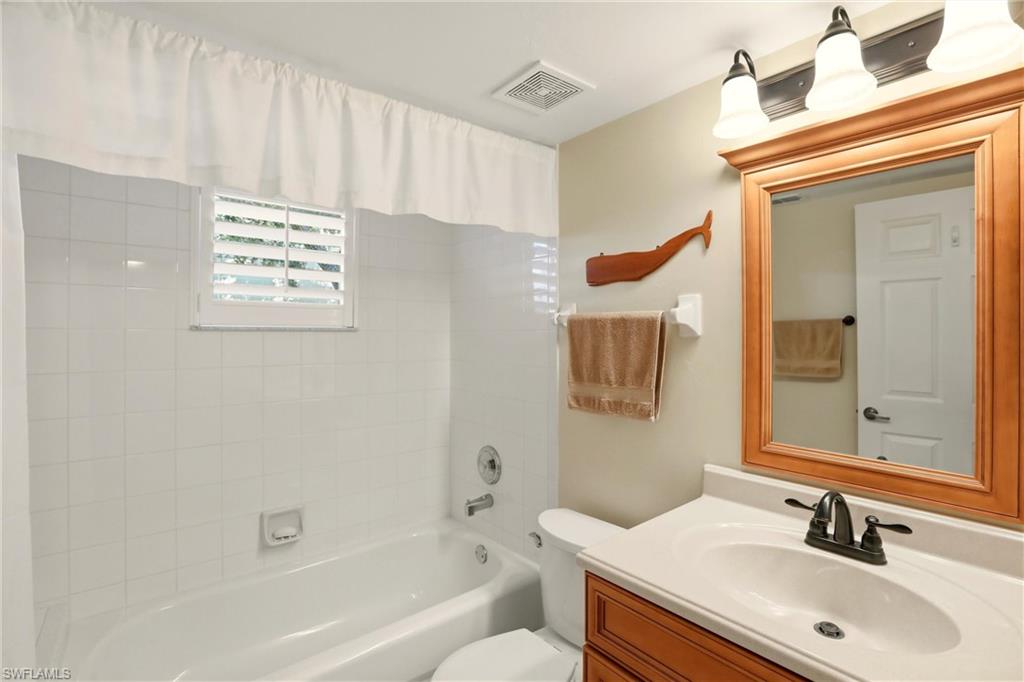 289 Robin Hood Circle, Unit 101 Naples, FL 34104 - Photo 26 of 47 a bathroom with a sink toilet and shower