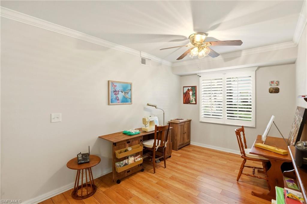 289 Robin Hood Circle, Unit 101 Naples, FL 34104 - Photo 28 of 47 a living room with furniture and a window