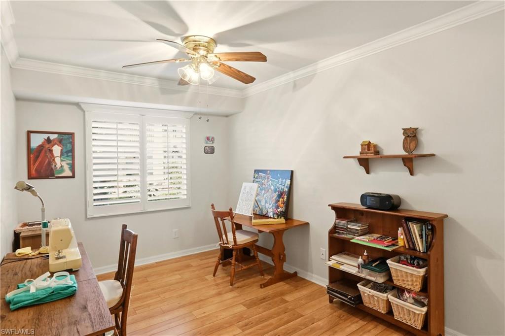 289 Robin Hood Circle, Unit 101 Naples, FL 34104 - Photo 29 of 47 a living room with furniture and a window