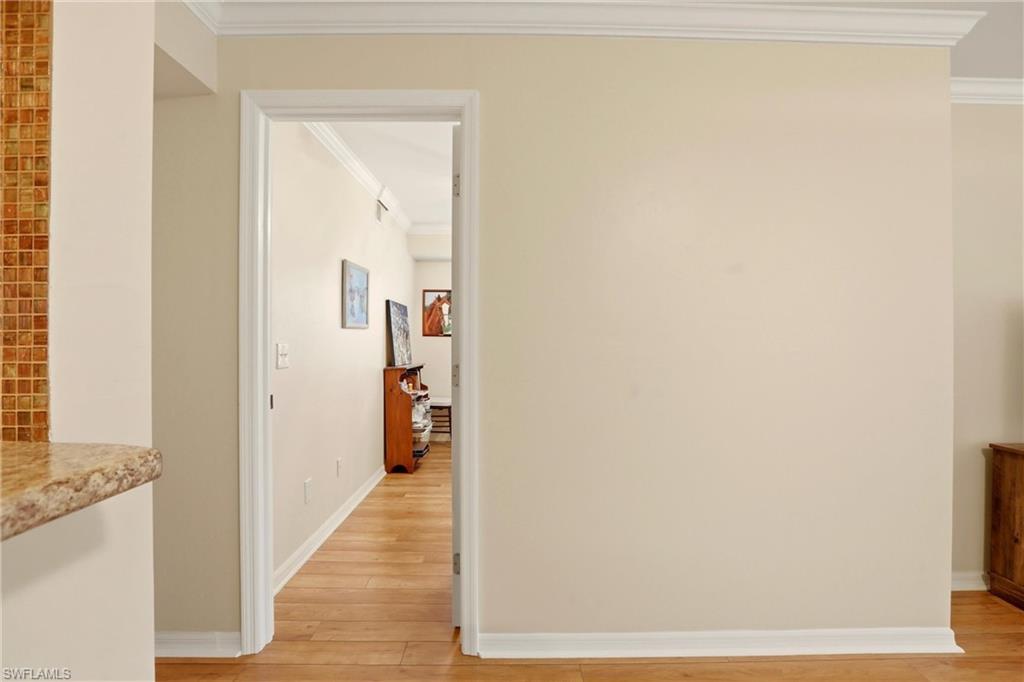 289 Robin Hood Circle, Unit 101 Naples, FL 34104 - Photo 30 of 47 a view of a hallway with wooden floor