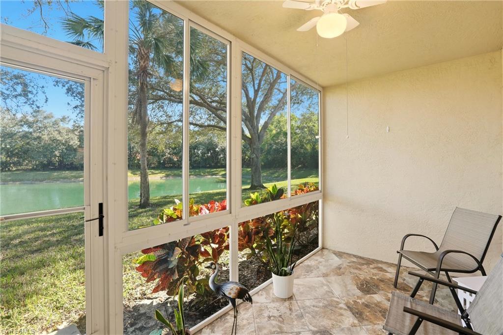 289 Robin Hood Circle, Unit 101 Naples, FL 34104 - Photo 33 of 47 a view of a porch with a table and chairs