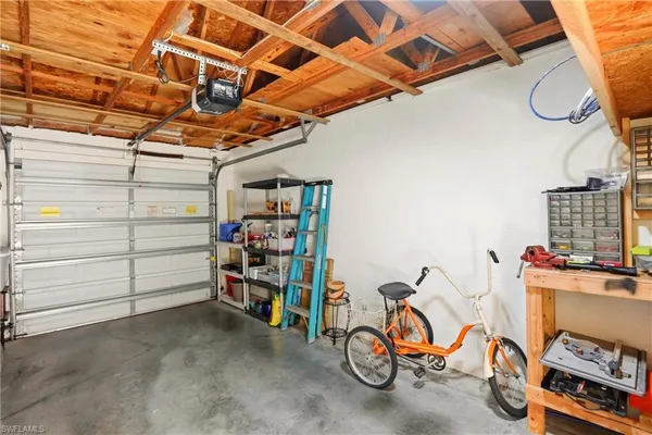 a view of a house with a yard and potted plants