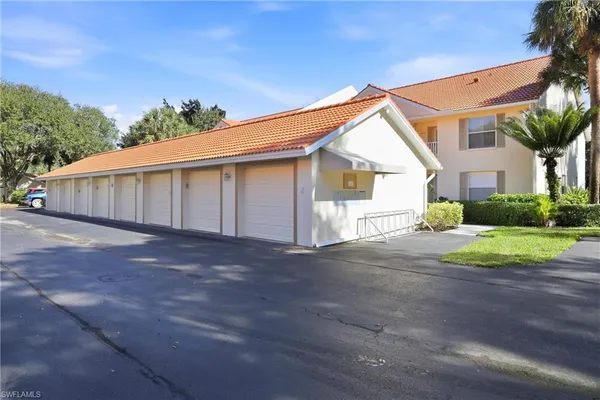 a living room with lots of furniture and view of kitchen