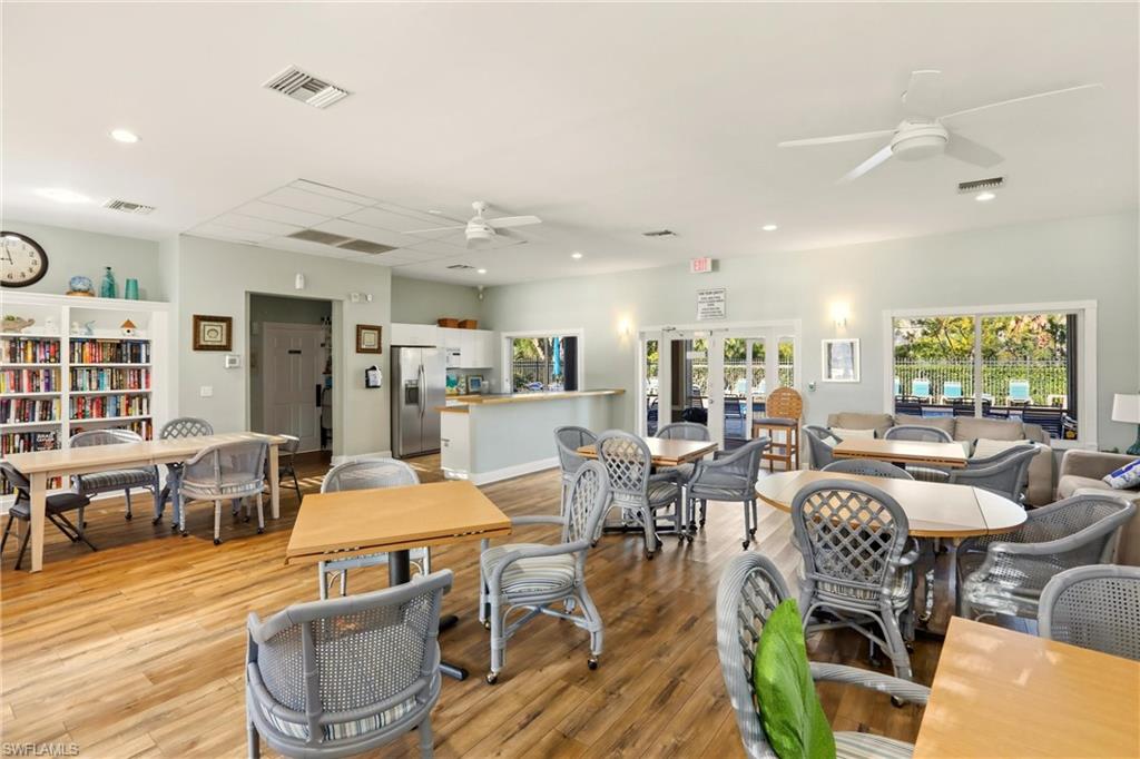 289 Robin Hood Circle, Unit 101 Naples, FL 34104 - Photo 41 of 47 a living room with lots of furniture and view of kitchen
