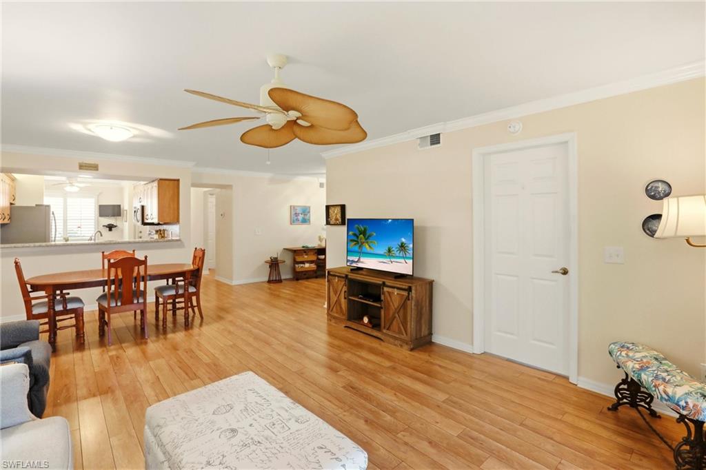 289 Robin Hood Circle, Unit 101 Naples, FL 34104 - Photo 6 of 47 a view of a dining room with furniture and wooden floor