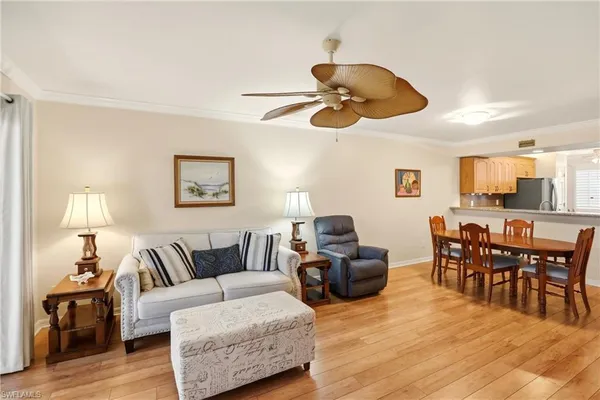 a kitchen with stainless steel appliances granite countertop a refrigerator a stove and a sink with wooden floor