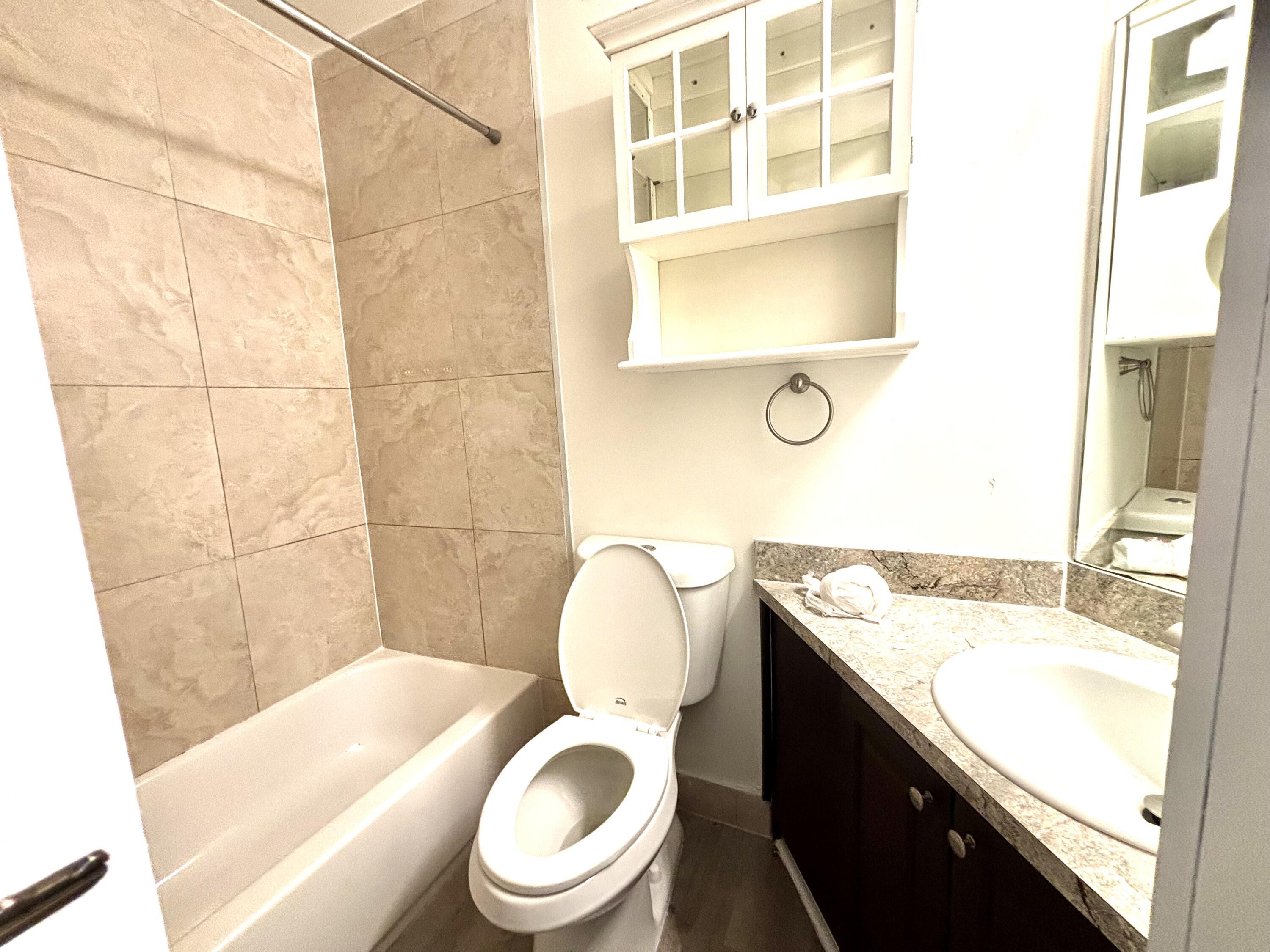 431 West Camino Real Boca Raton, FL 33432 - Photo 11 of 11 a bathroom with a granite countertop toilet sink and mirror