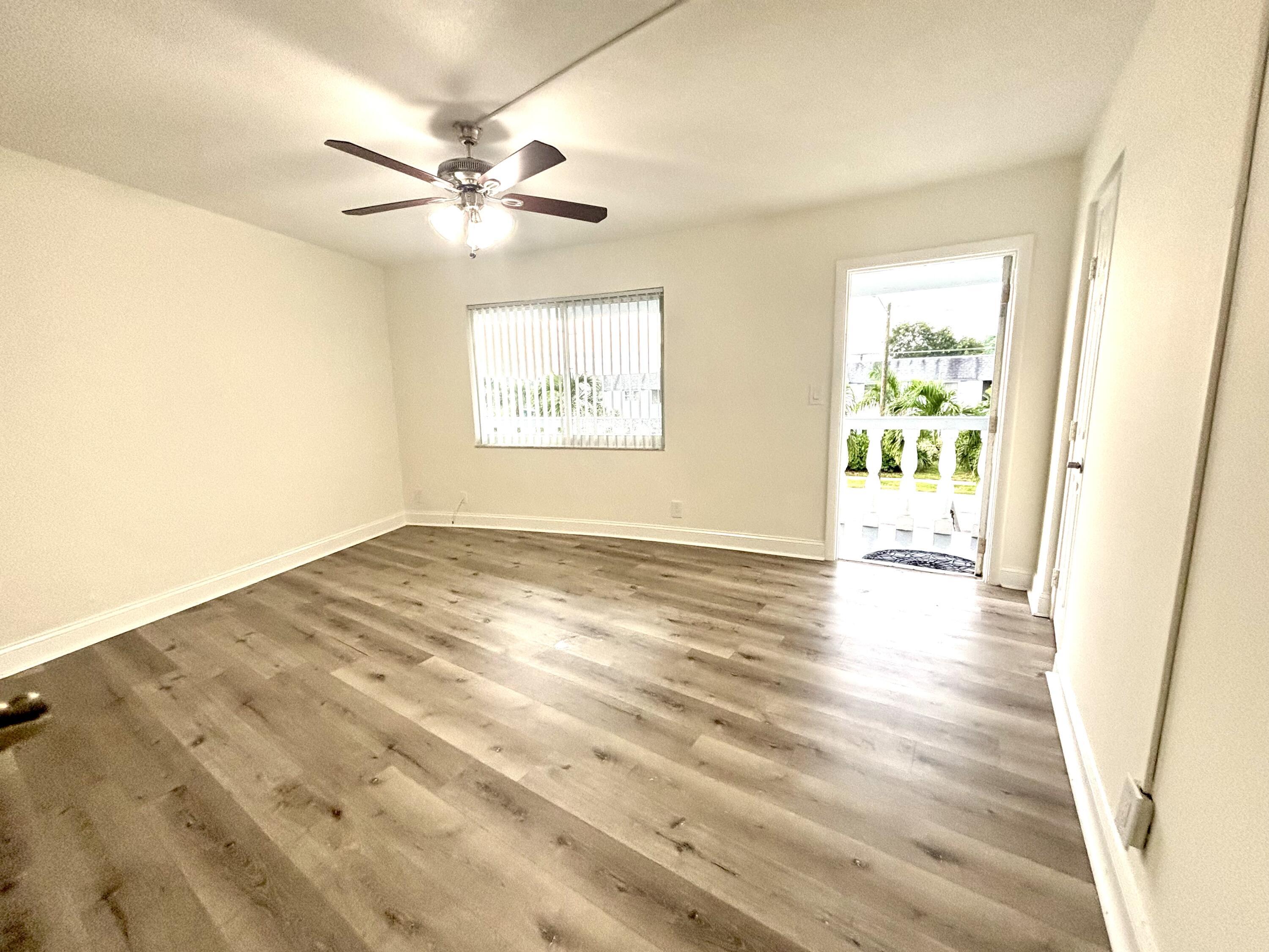 431 West Camino Real Boca Raton, FL 33432 - Photo 6 of 11 wooden floor in an empty room with a window