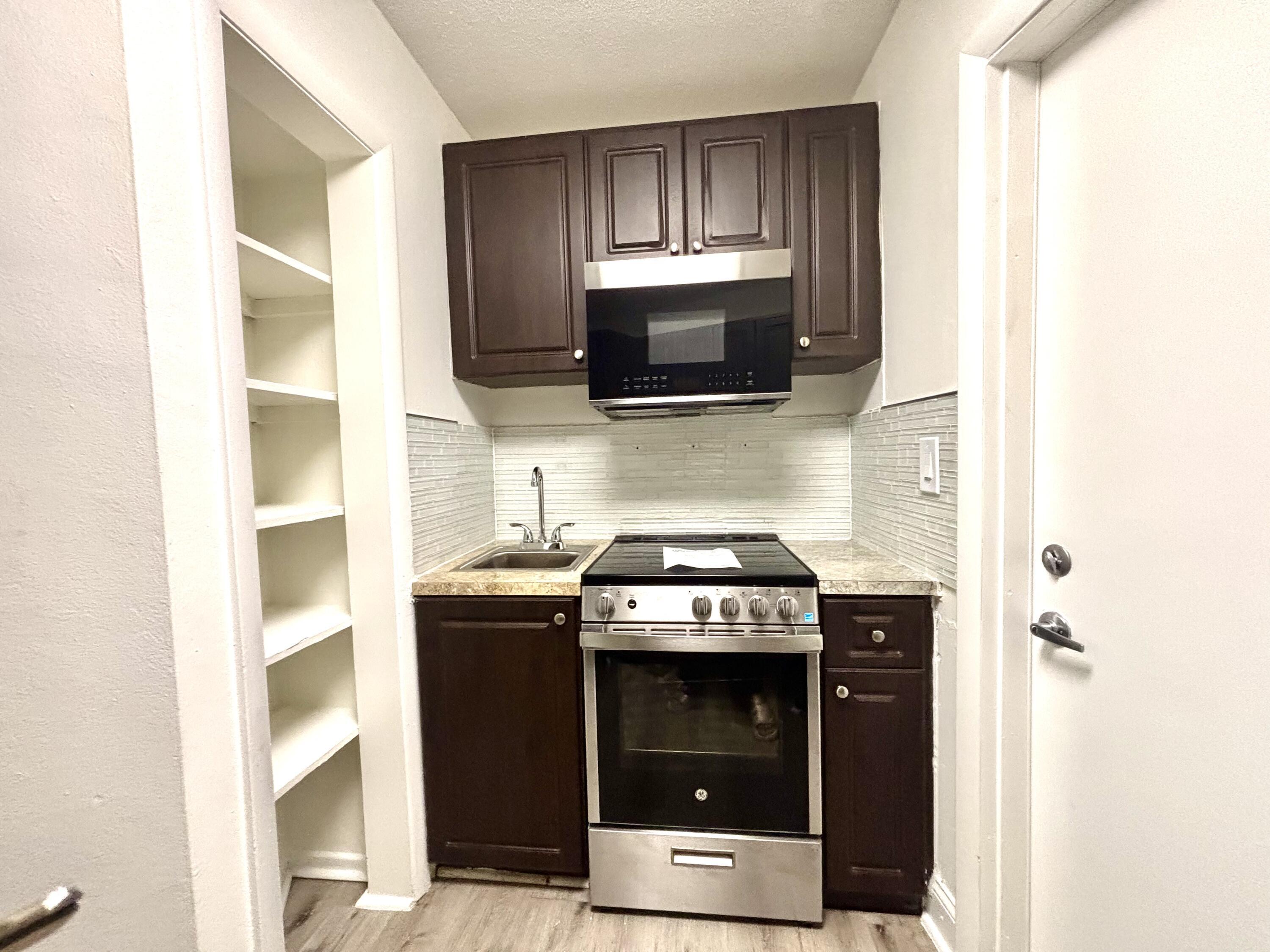 431 West Camino Real Boca Raton, FL 33432 - Photo 10 of 11 a kitchen with a stove and a microwave