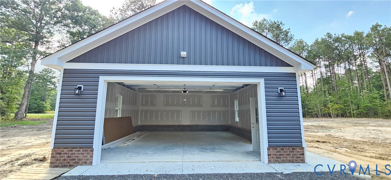 2982 Ashdale Road Center Cross, VA 22437 - Photo 7 of 17 Two-car garage featuring blue horizontal siding, a