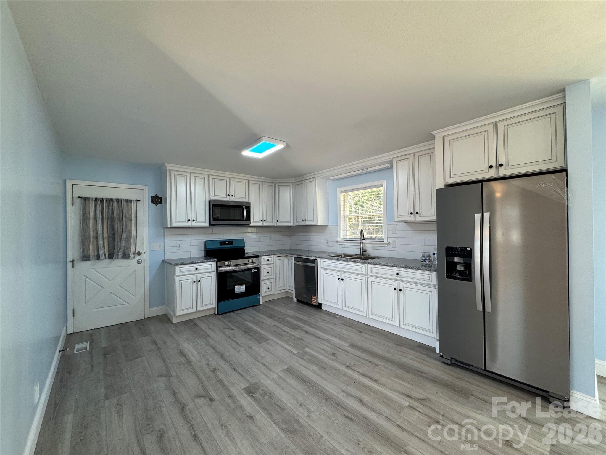 1307 Armstrong Road Belmont, NC 28012 - Photo 4 of 15 a kitchen with stainless steel appliances a refrigerator sink and cabinets