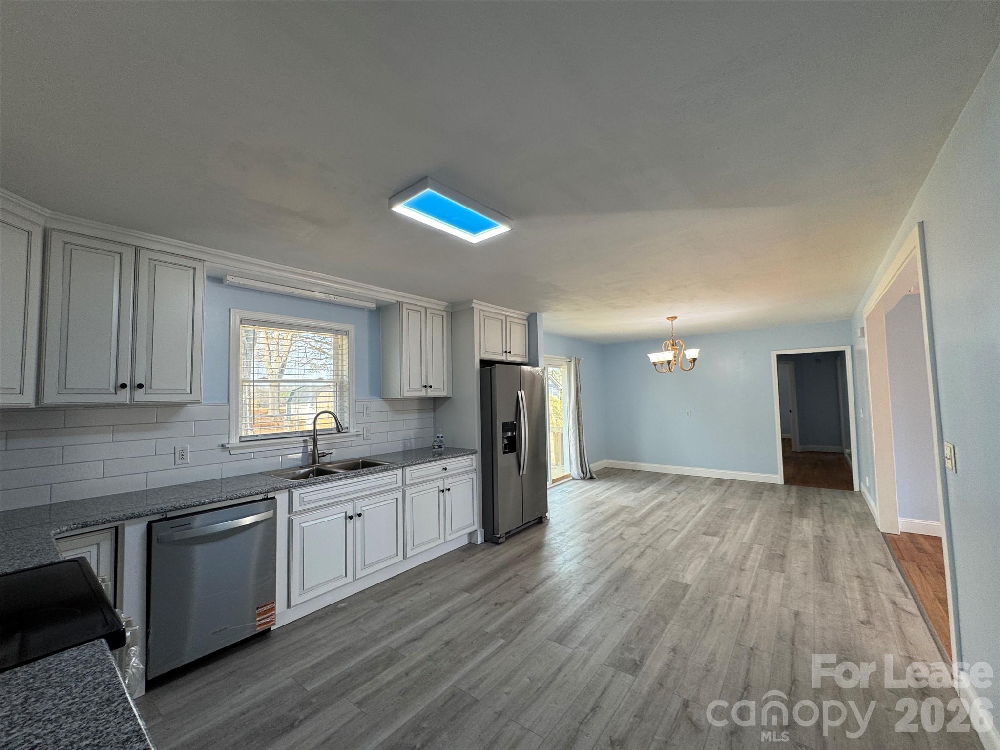 1307 Armstrong Road Belmont, NC 28012 - Photo 5 of 15 a kitchen with stainless steel appliances granite countertop a sink cabinets and wooden floor