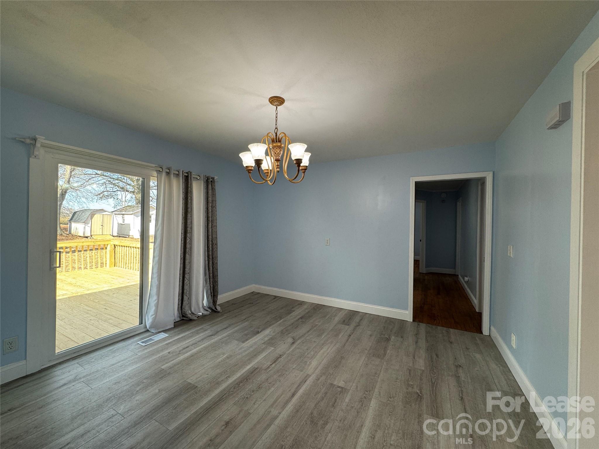 1307 Armstrong Road Belmont, NC 28012 - Photo 6 of 15 wooden floor in an empty room with a window