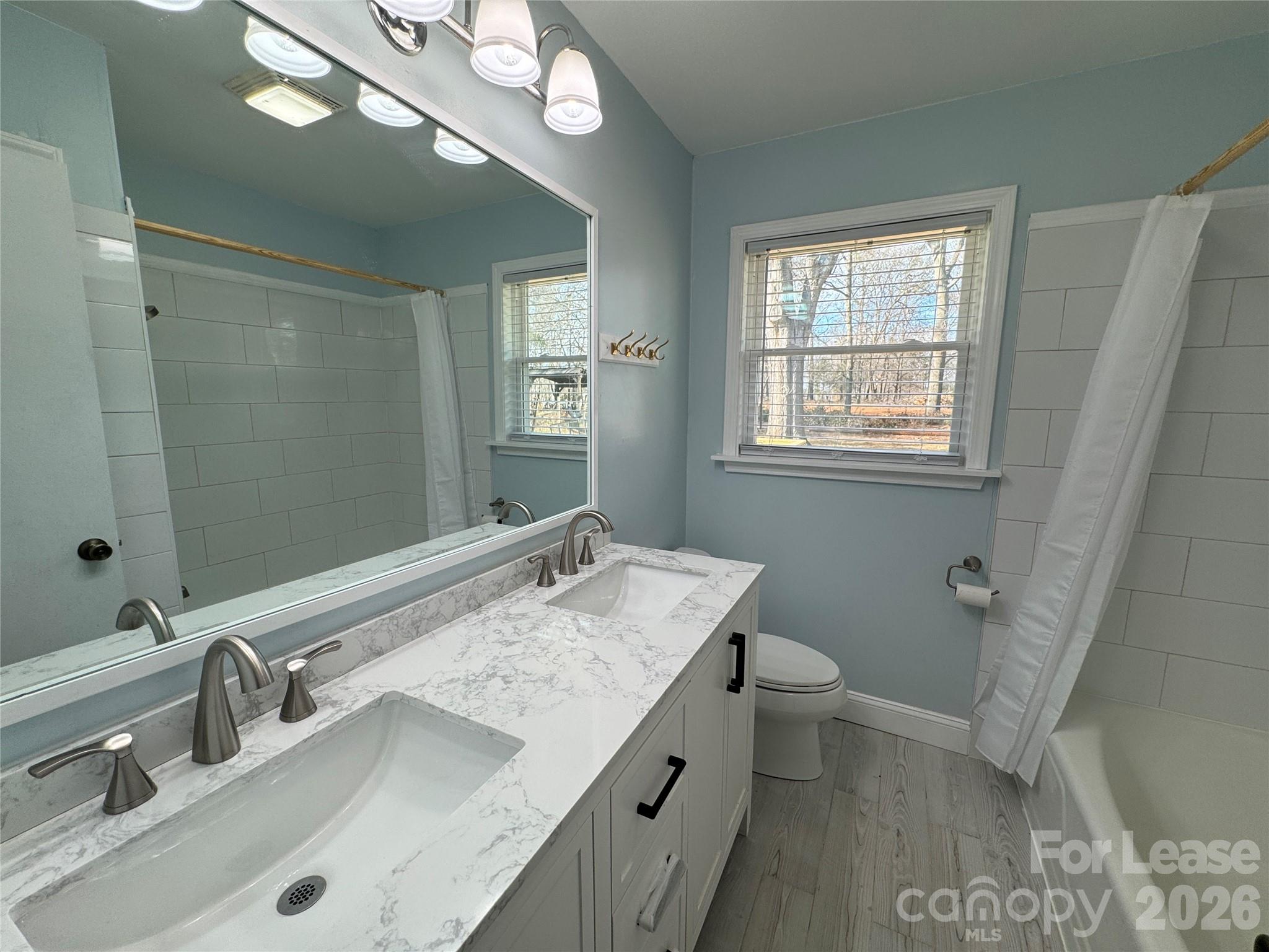 1307 Armstrong Road Belmont, NC 28012 - Photo 7 of 15 a bathroom with a granite countertop sink a toilet and a mirror