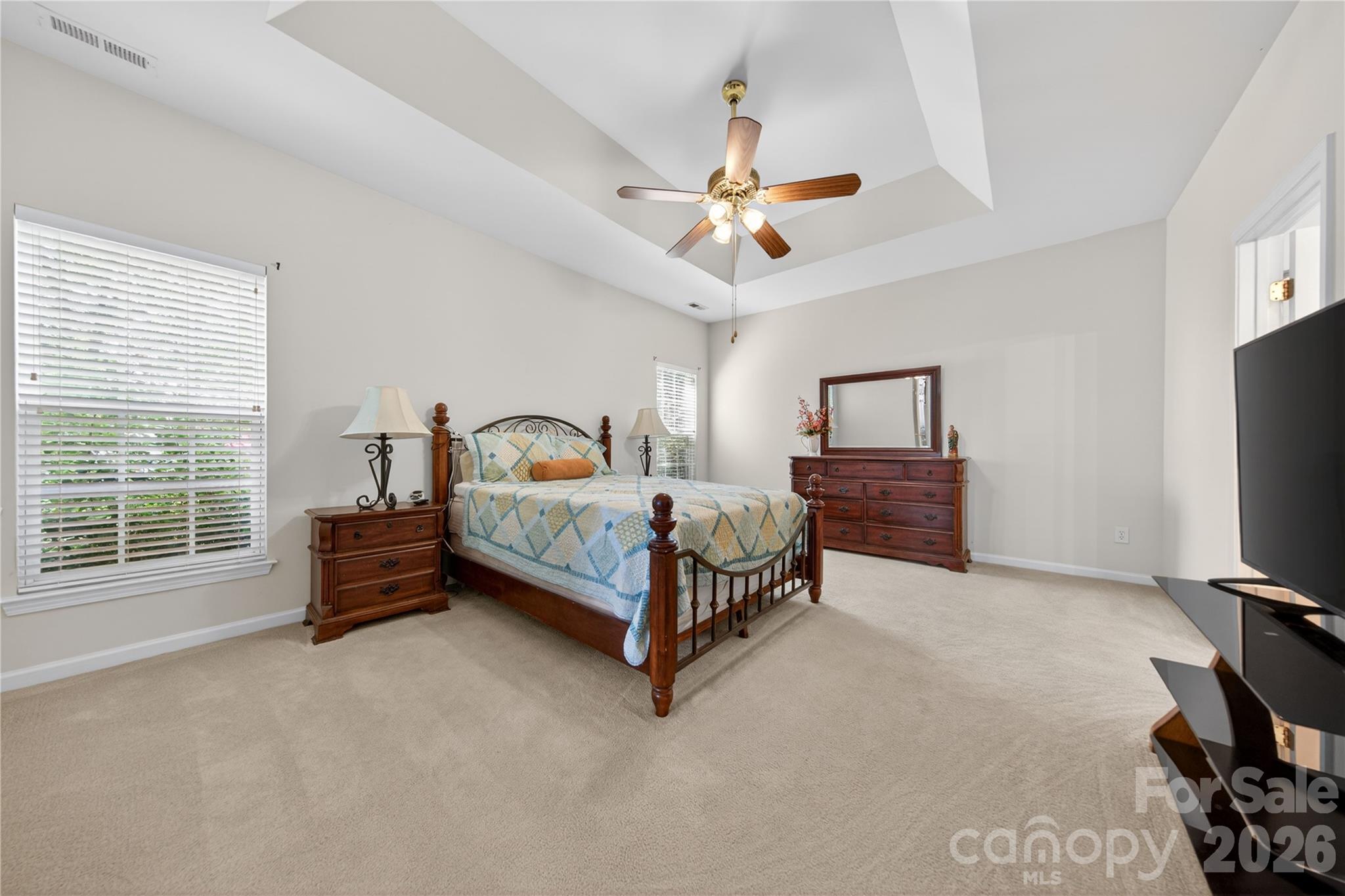 533 Fair Oaks Drive Fort Mill, SC 29708 - Photo 16 of 33 a spacious bedroom with a bed and a flat tv screen on dresser