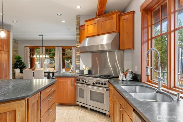 a kitchen with stainless steel appliances granite countertop a refrigerator and cabinets