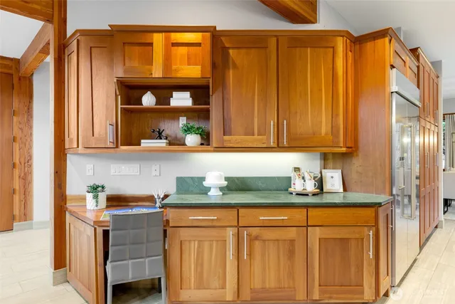 a kitchen with stainless steel appliances granite countertop a refrigerator a sink and a stove