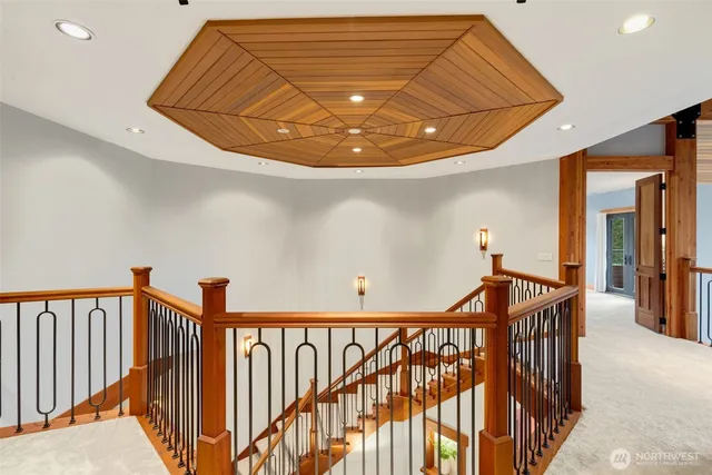 a spacious bedroom with a large bed and a chandelier