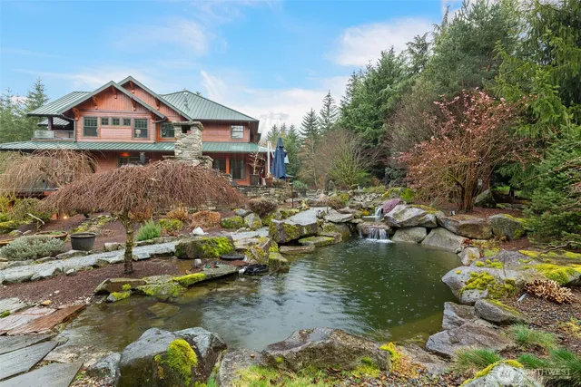 a view of backyard with a table and chairs under an umbrella