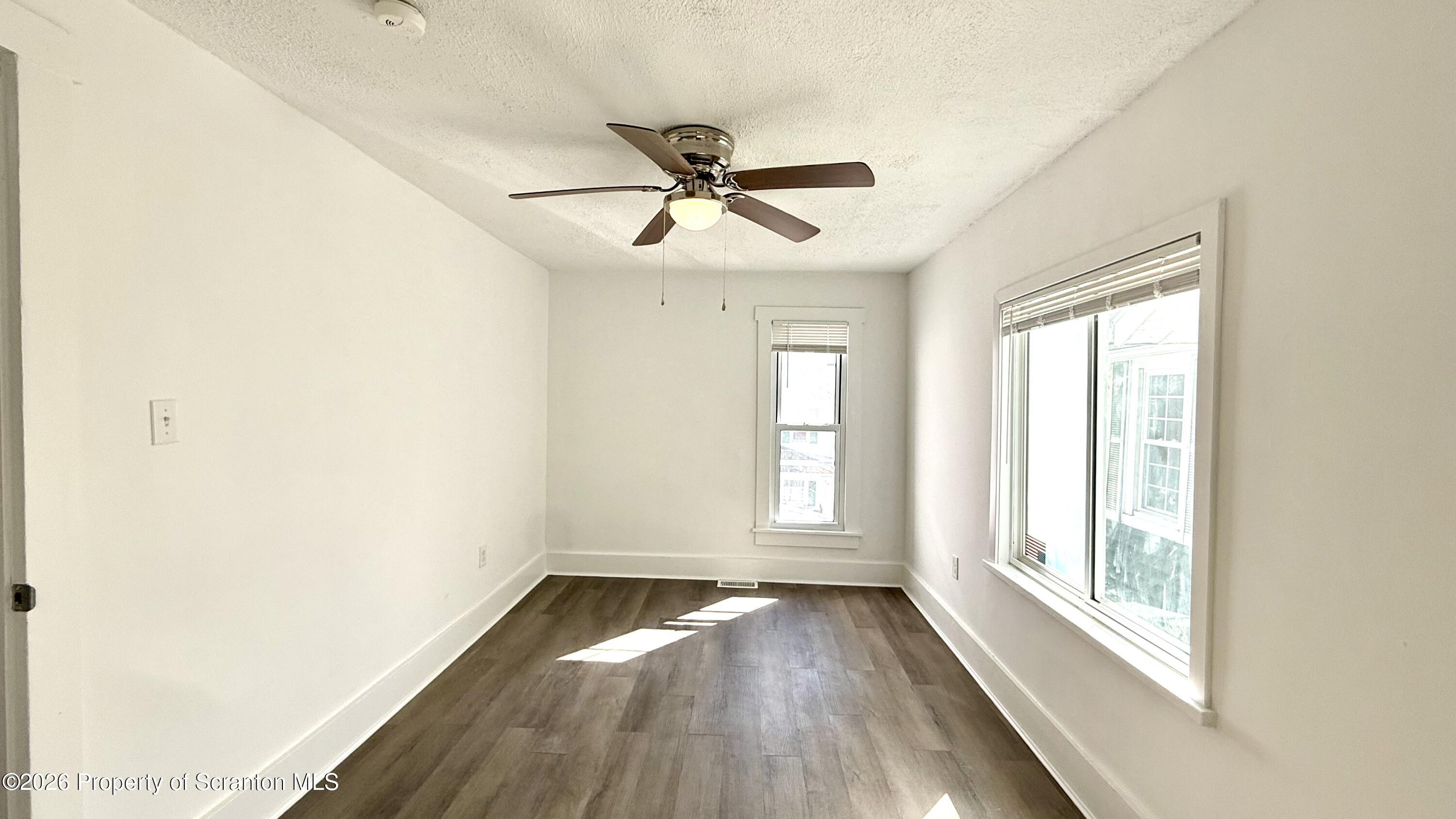 1032 Chestnut Street Sunbury, PA 17801 - Photo 11 of 25 a view of empty room with wooden floor and fan
