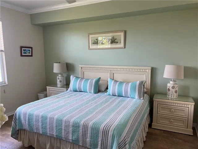 a bedroom with a bed and a wooden floor