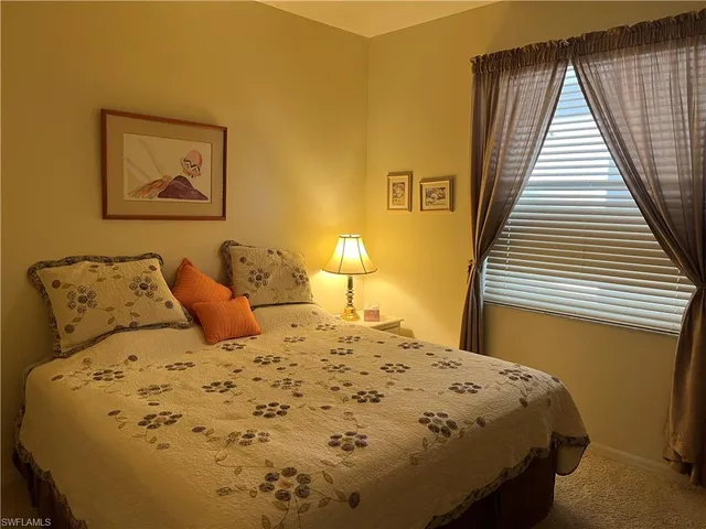 a bedroom with a bed and flat screen tv