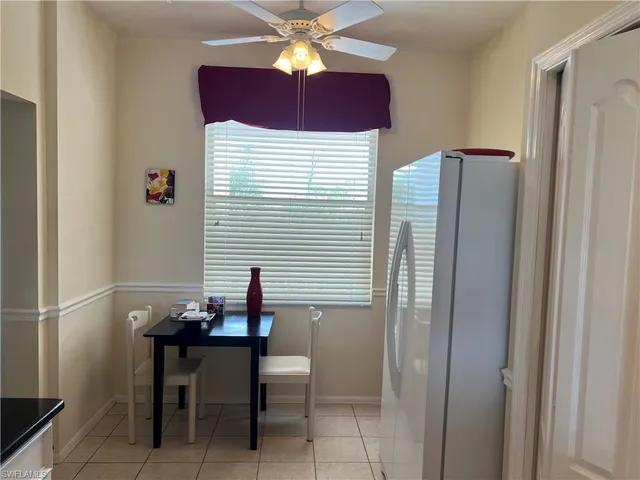 a living room with furniture a chandelier and a window