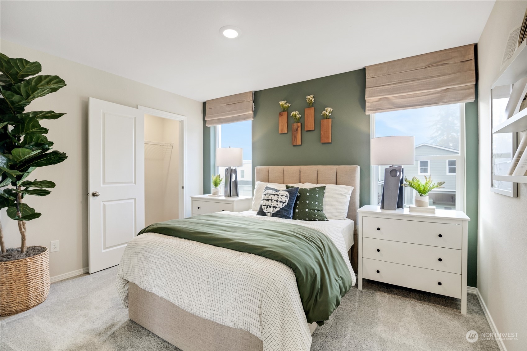 13929 197th Street East, Unit 247 Graham, WA 98338 - Photo 15 of 18 a bedroom with a bed and a potted plant