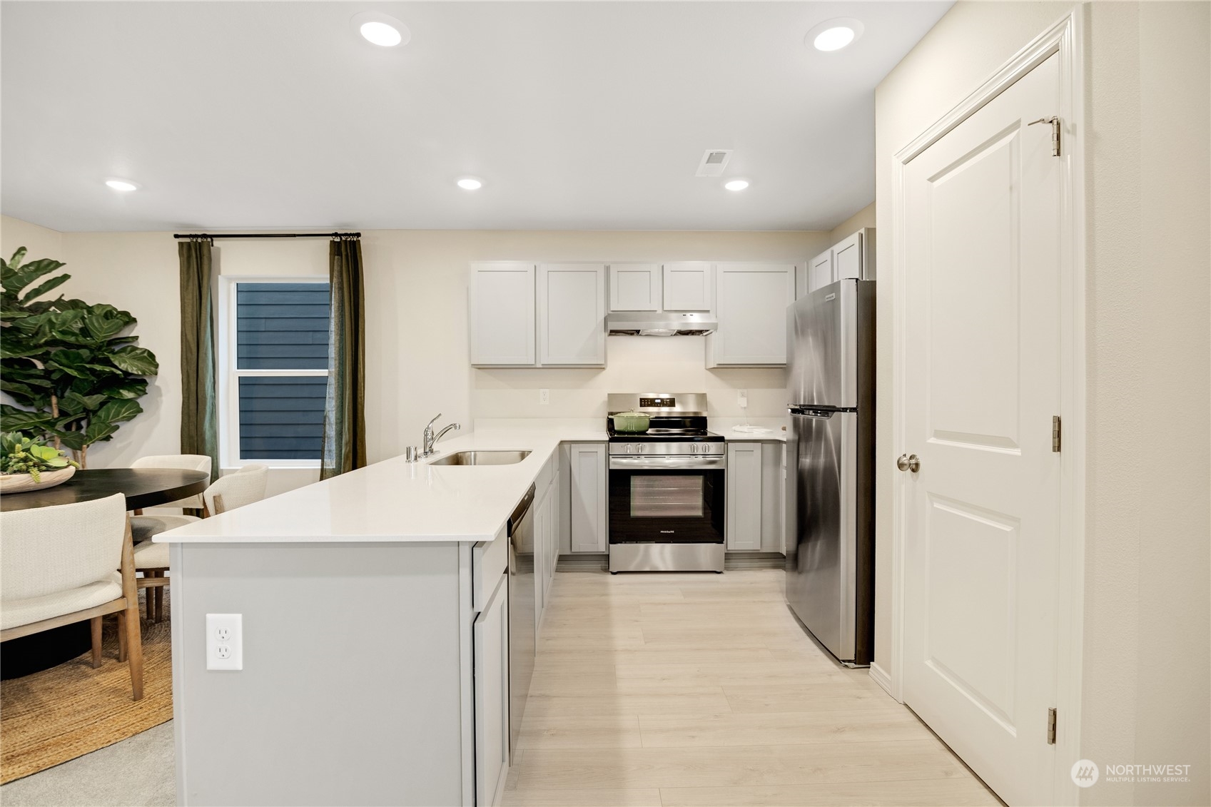 13929 197th Street East, Unit 247 Graham, WA 98338 - Photo 3 of 18 a kitchen with a refrigerator a stove and a cabinets