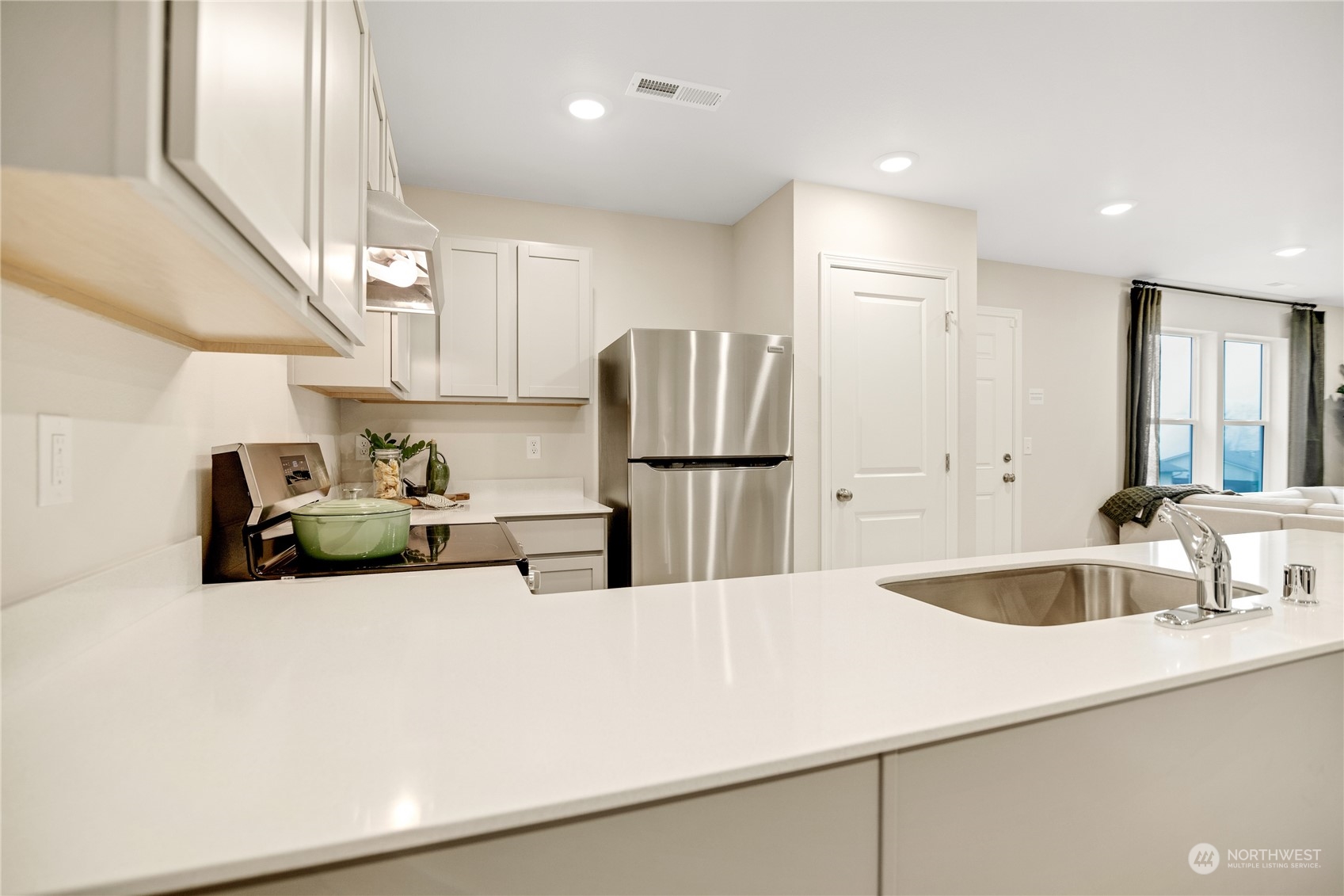 13929 197th Street East, Unit 247 Graham, WA 98338 - Photo 8 of 18 a kitchen with stainless steel appliances a sink and a refrigerator