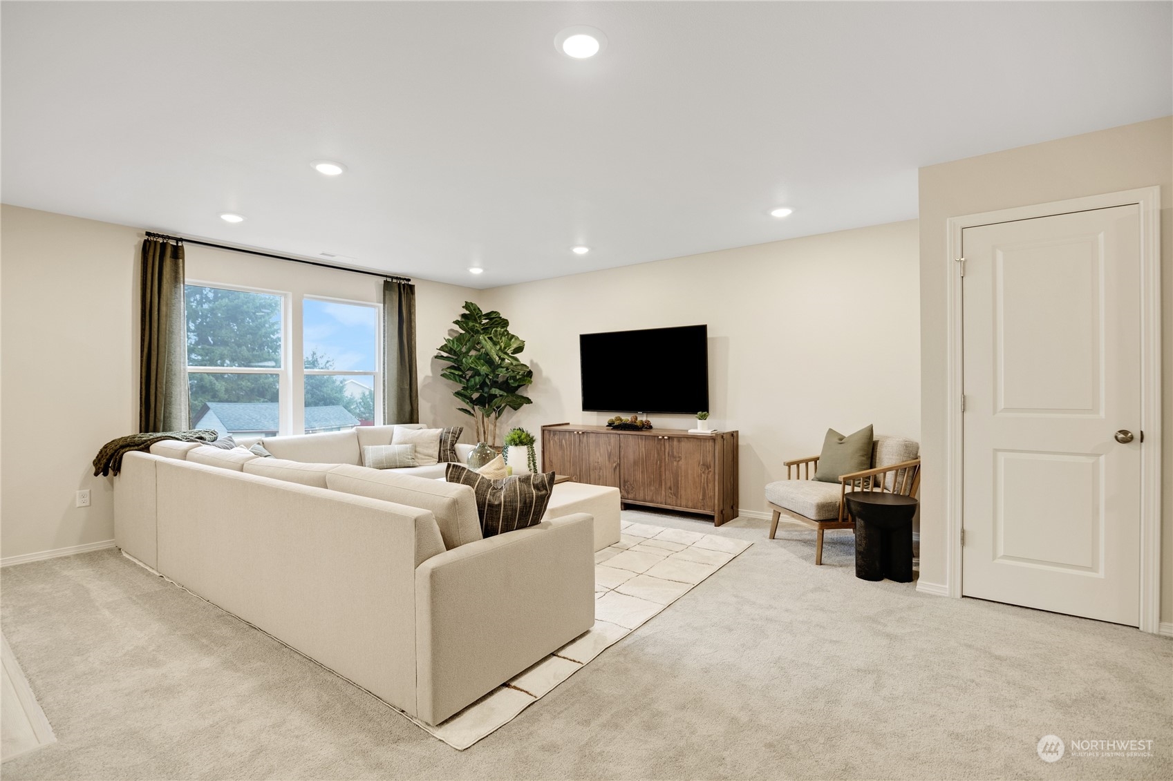 13929 197th Street East, Unit 247 Graham, WA 98338 - Photo 9 of 18 a living room with furniture and a flat screen tv