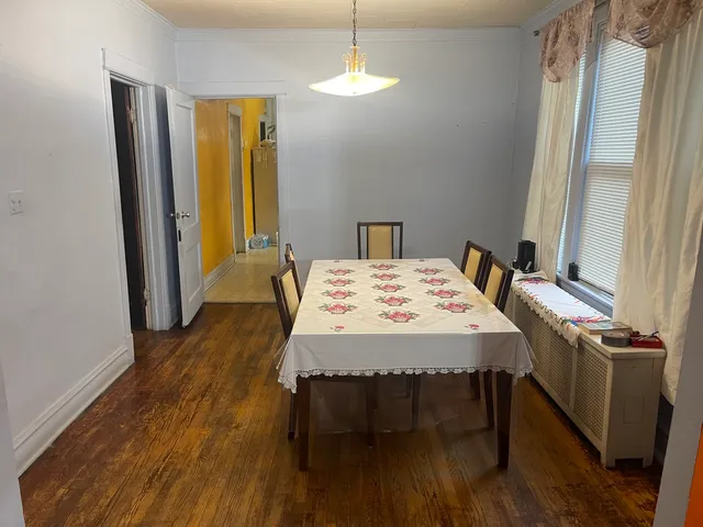 a dining room with a table chairs and a chandelier