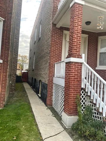 a view of a brick house with many windows