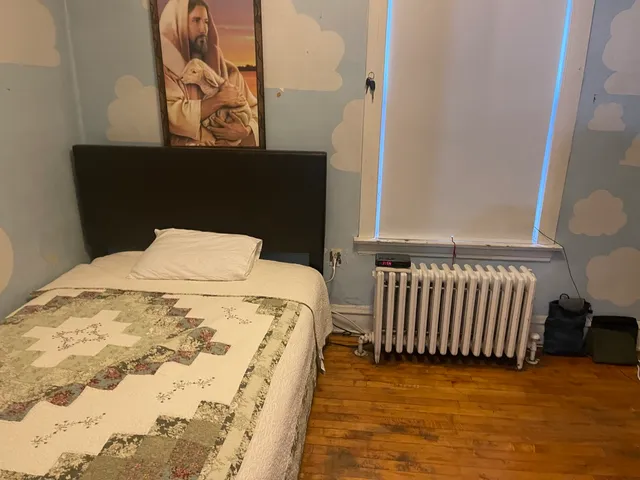 a bed sitting in a bedroom next to a small yard