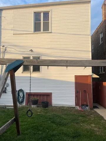 a view of a backyard with chairs and a fireplace