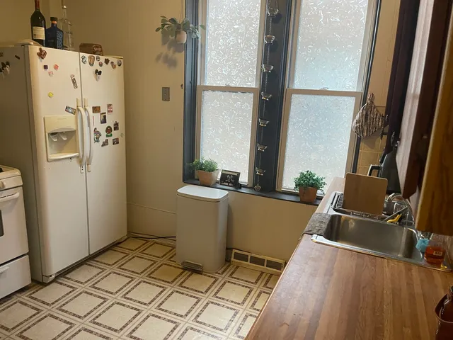 a room with a refrigerator and a window