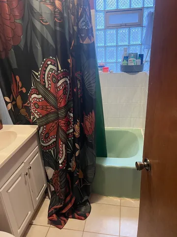 a bathroom with a bathtub and shower