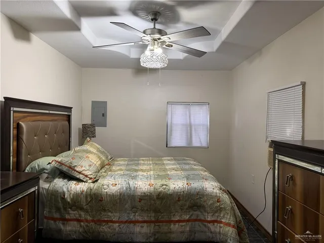 a bedroom with a bed and a ceiling fan